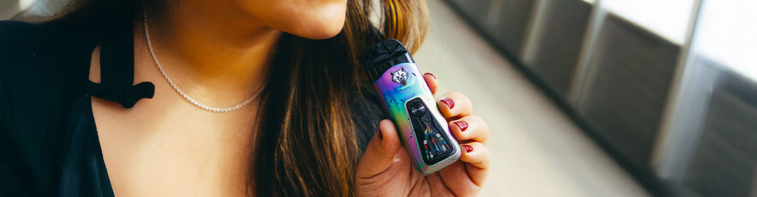 woman holding the Wulf Flex Dry Herb Vaporizer outside near park