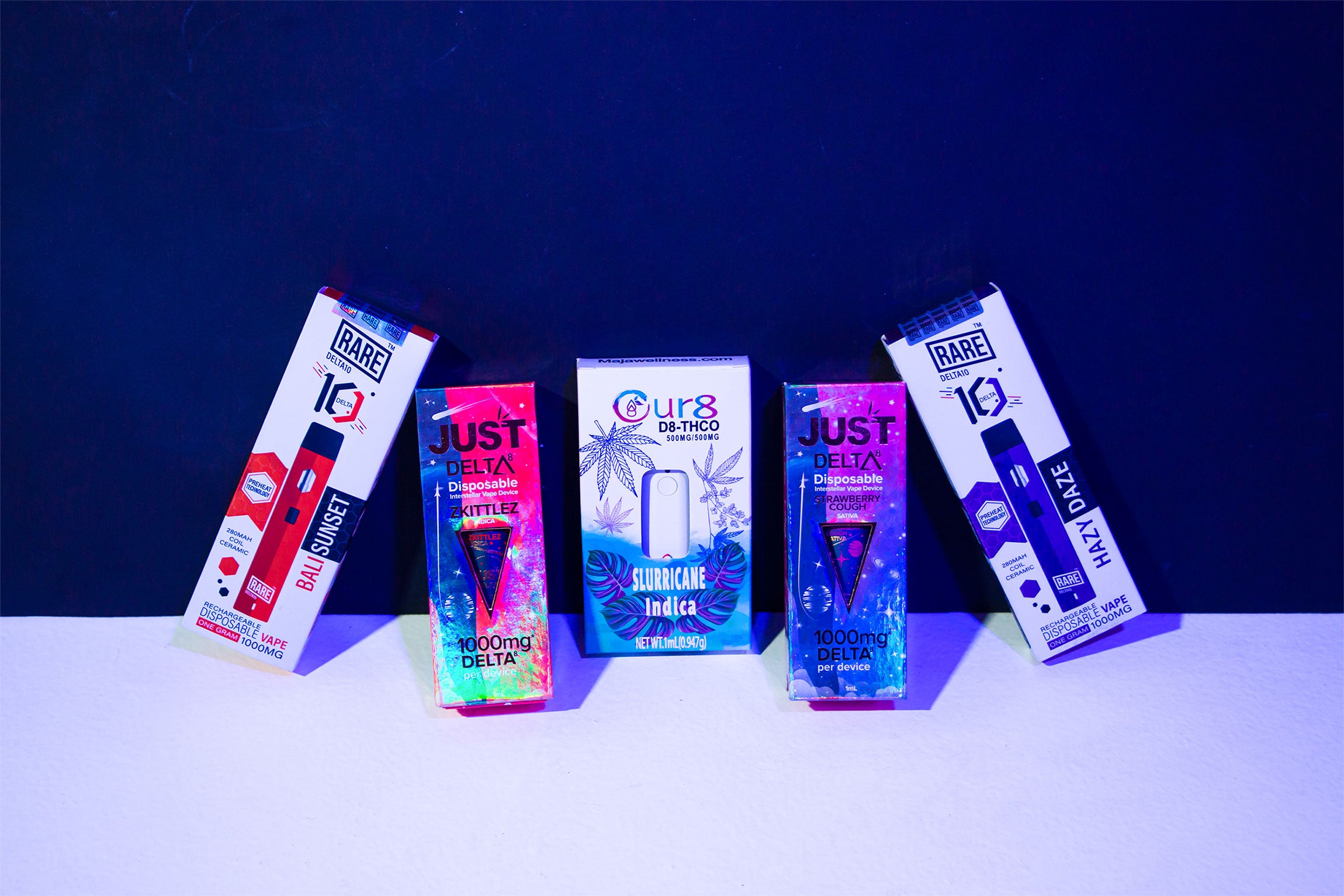 Colorful Wholesale CBD Vape Disposable packaging on black and white background 