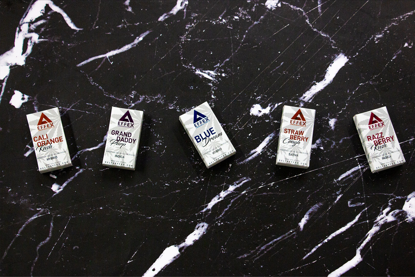 Wholesale Delta Effex various flavors laying down on black and white marble textured table