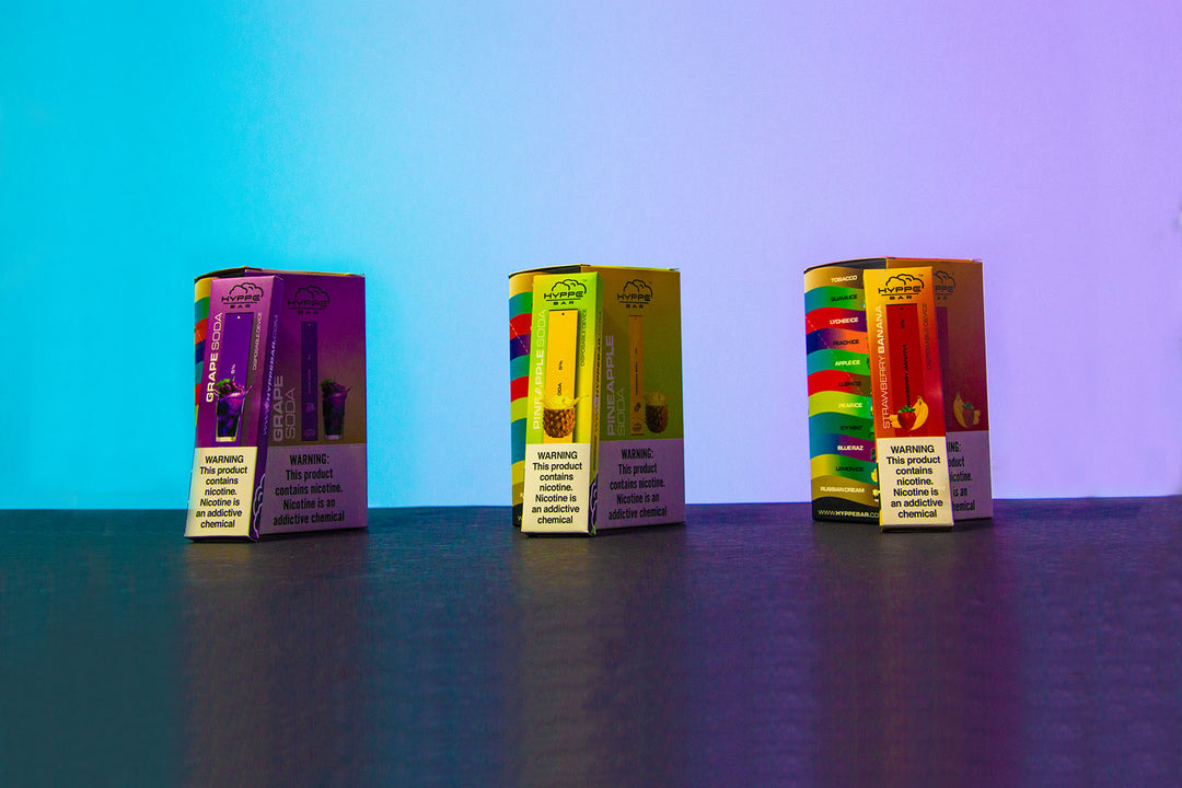 Wholesale Hyppe Bar Disposables in a row on colorful studio background