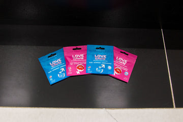 Wholesale Love Bear Single packets laying down on black tile in office