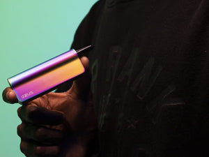 Exxus Snap VV Pro in man's hands with teal studio background