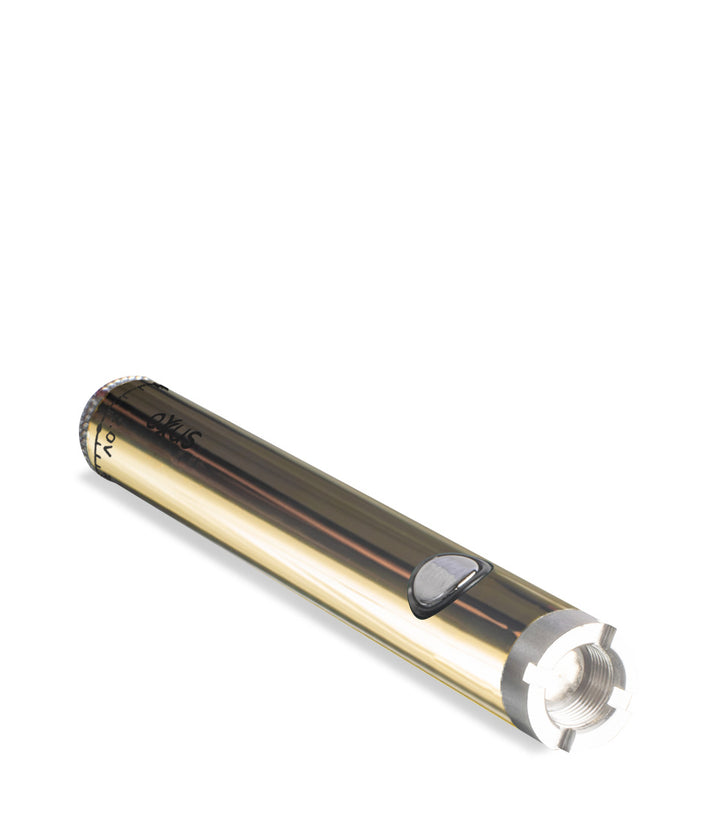 Gold laying down Exxus Vape Twistr Cartridge Vaporizer on white studio background