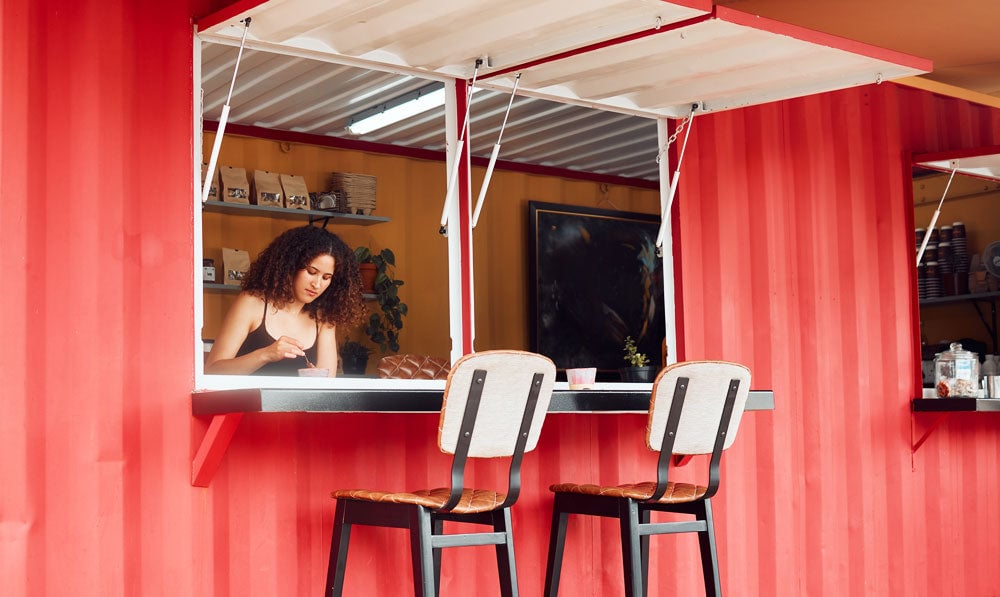 Woman at a pop up shop with the windows open