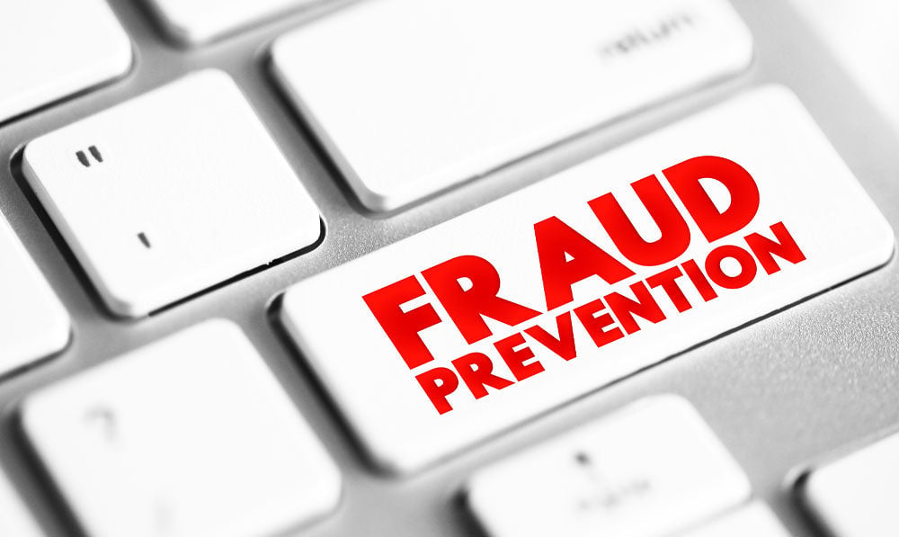Fraud prevention key on a white keyboard
