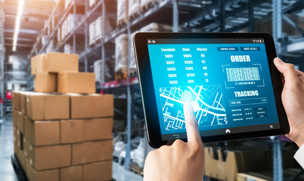 Warehouse worker assessing inventory through orders and tracking