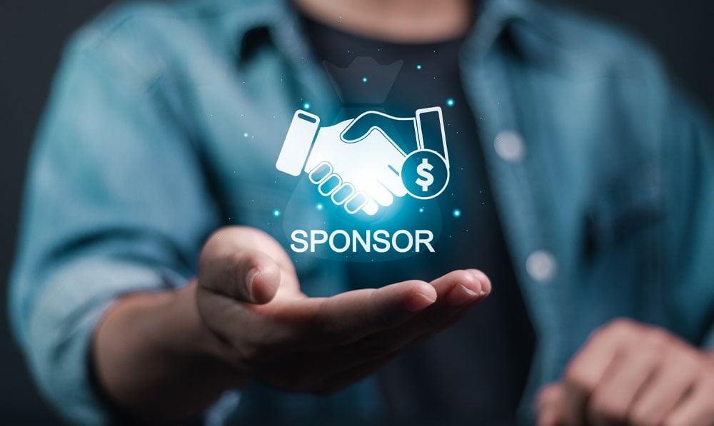 Man with floating Sponsor Icon in palm of hand