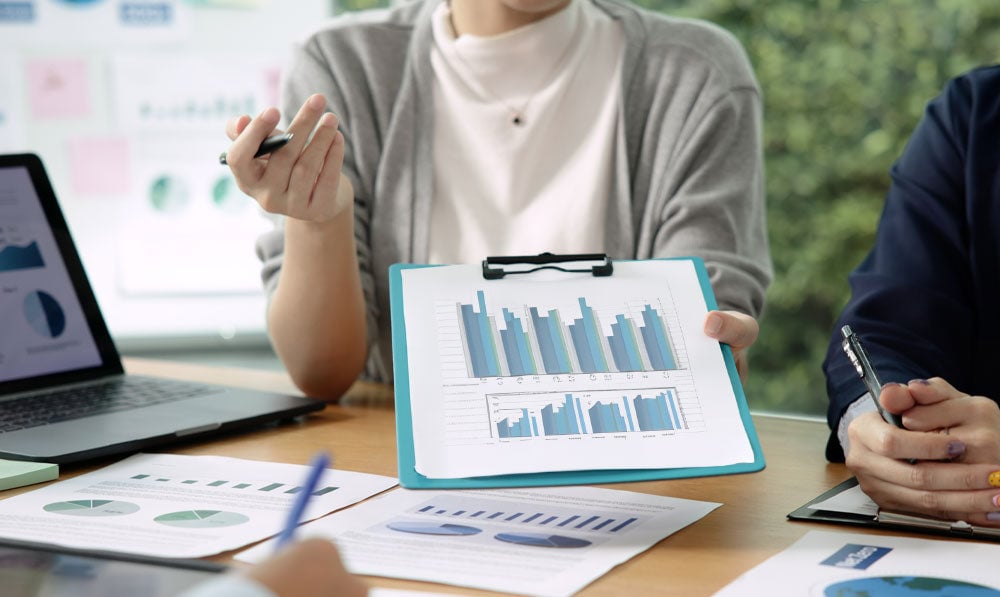 Woman sharing pricing data and figures among colleagues