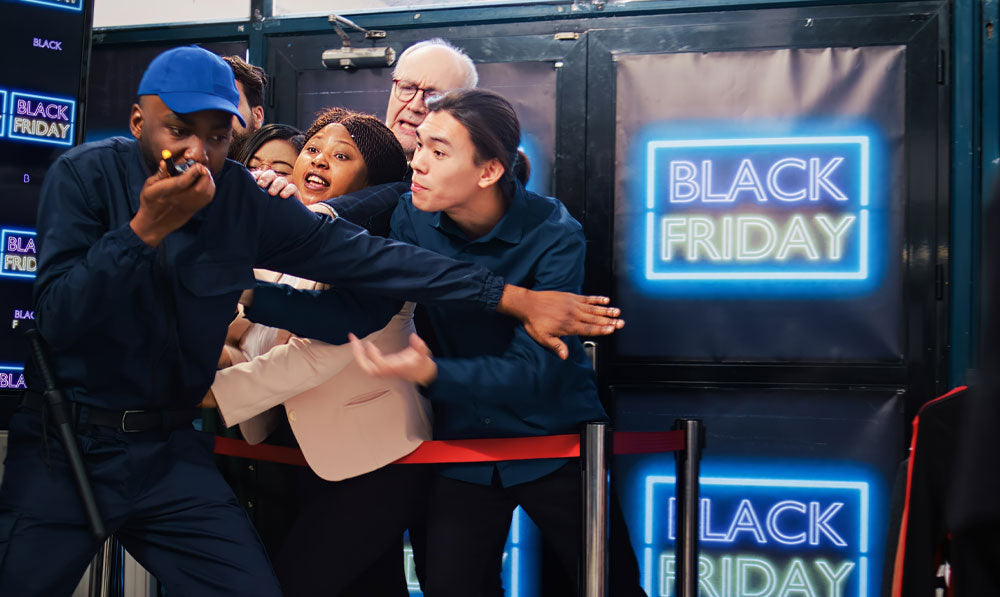 Employee struggling with excited black friday customers