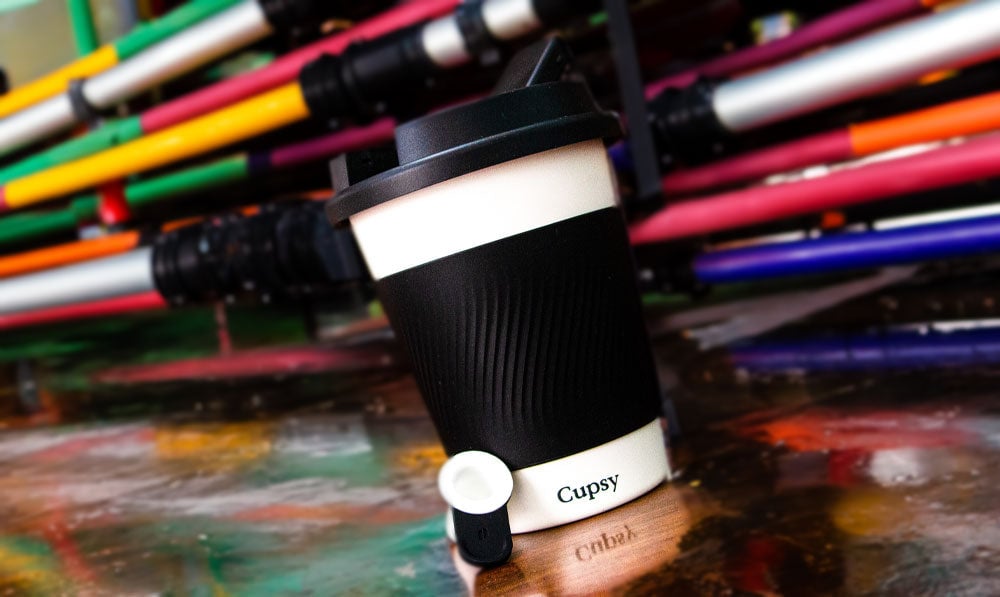 Puffco Cupsy outside near water pipes