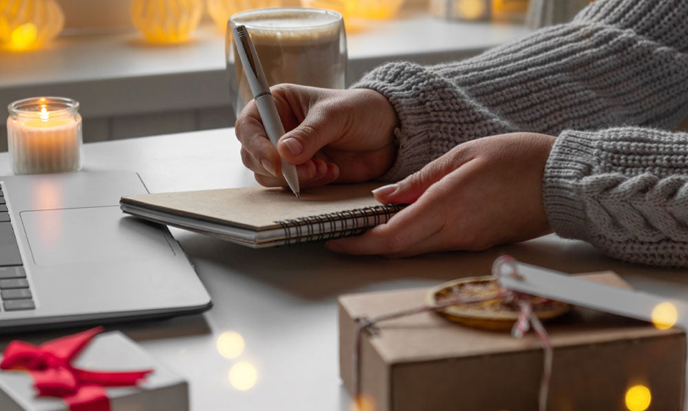 Person writing up sales on notebook