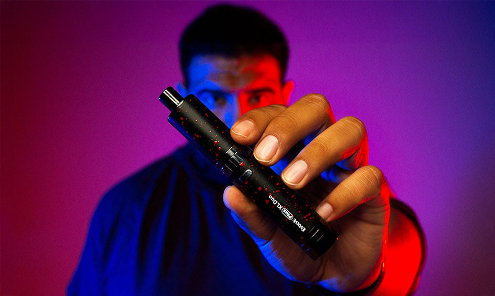 Man holding Wulf Evolve Plus XL Duo in front of purple and blue studio lighting