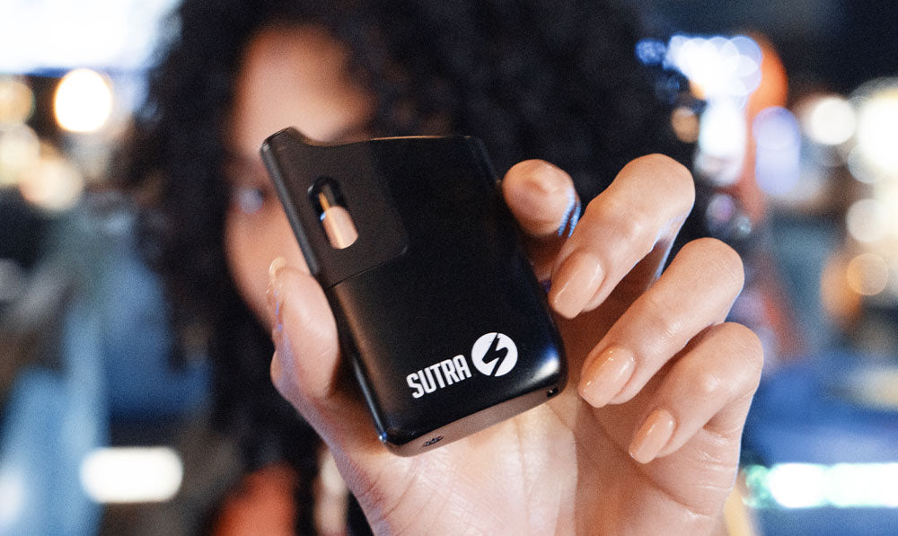 Woman holding Sutra Mini in an arcade