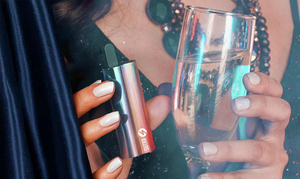 Woman holding Sutra Auto with wine glass in other hand