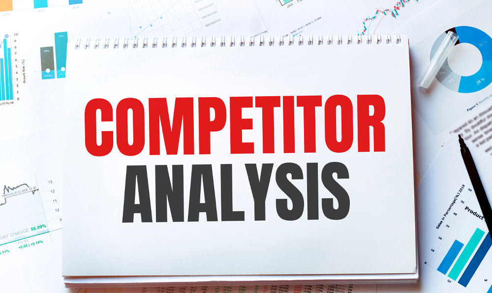 Competitor analysis notebook near notes and pens
