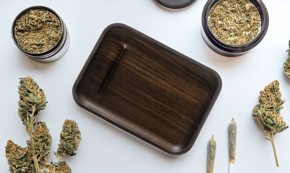 PAX Walnut Prep Tray on wooden table with dry herb and blunts