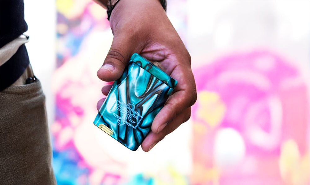 Man holding Quantum PAC with small dugout in front of pastel wall