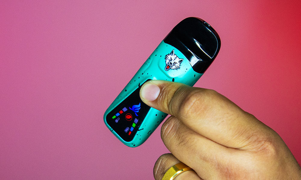 man holding the Wulf Flex Dual Use Vaporizer with red background