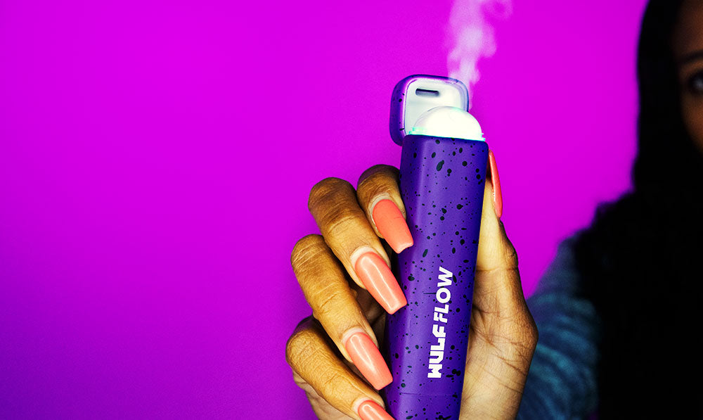 Woman holding Wulf Flow opened with purple background
