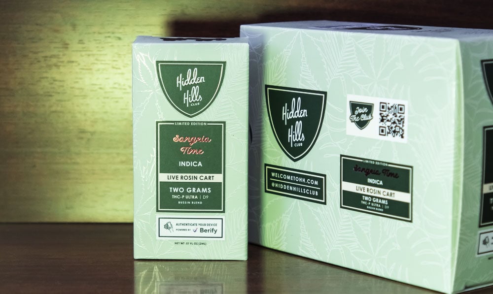 Hidden Hills Bussin Blend cartridges on wooden reflective surface with packaging nearby