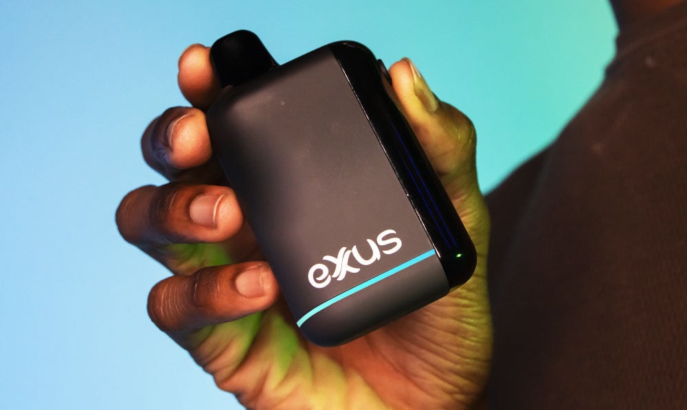Man holding Exxus Snap DLX in front of blue studio background