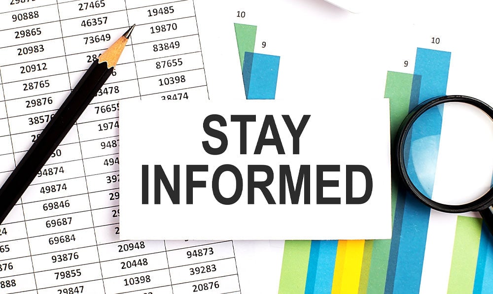 Stay Informed Graphic On Office Desk With Supplies