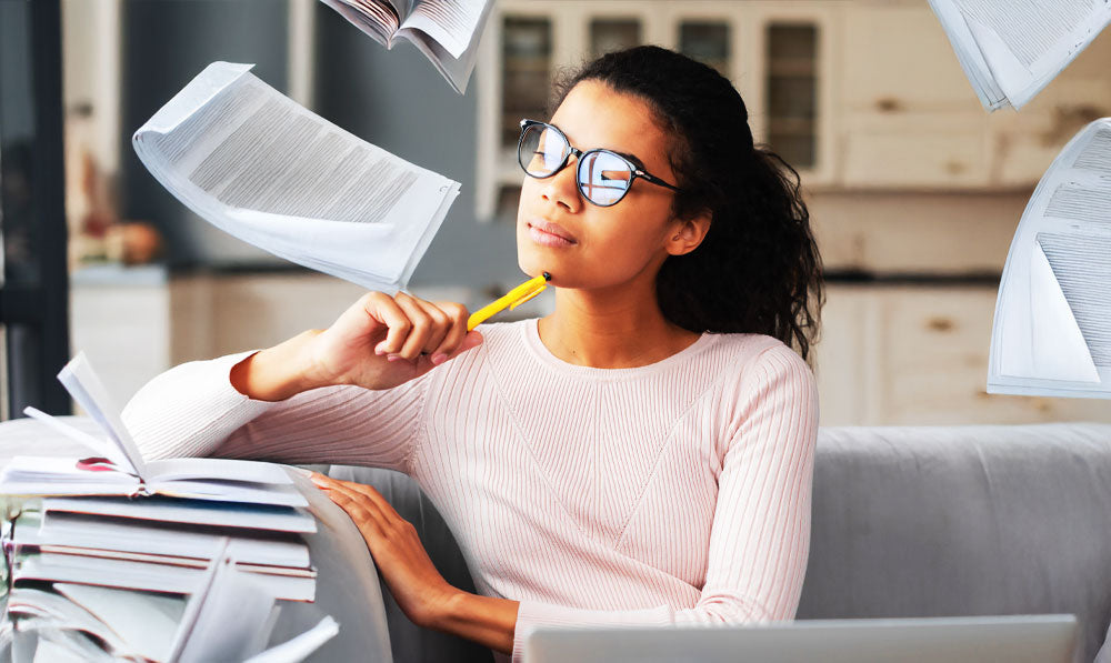 Woman Planning With Falling Pages Nearby