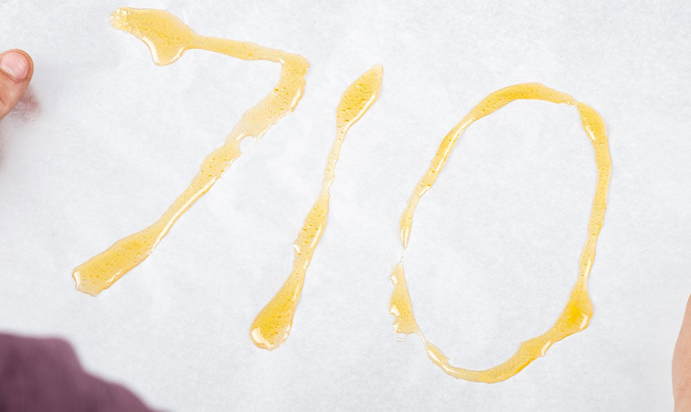 Person holding 710 on a piece of paper