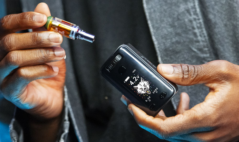 Man in denim jacket holding Wulf UNI 3 with cartridge nearby