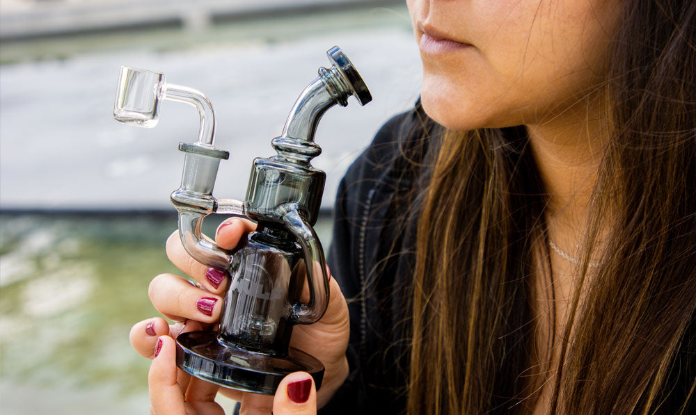 woman holding Alpha Dab Rig at park