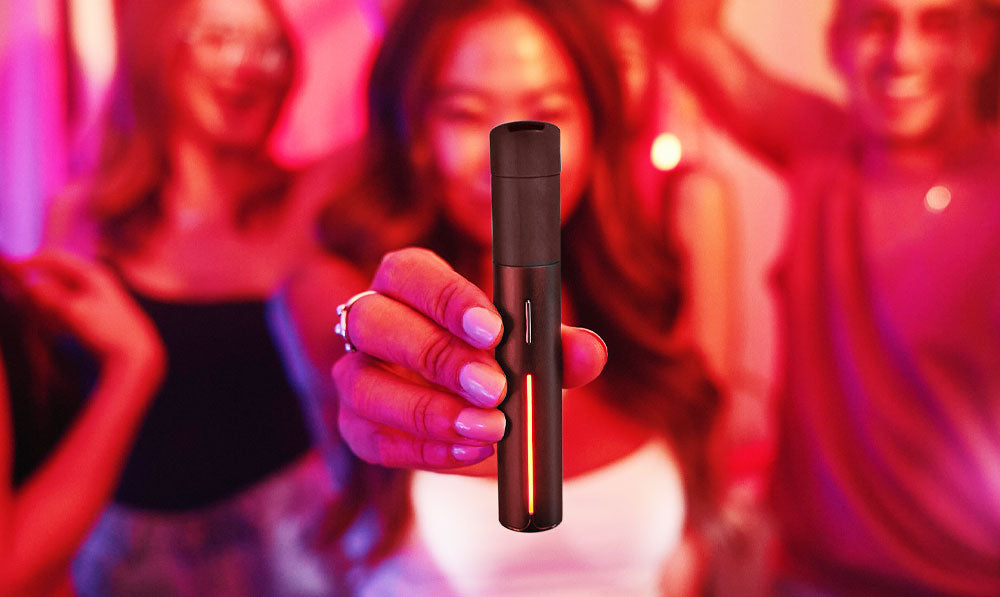 Woman holding Puffco Pivot Mocha at a party