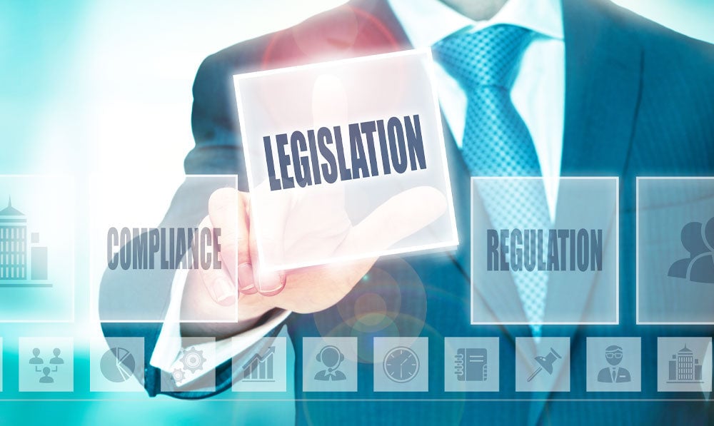 Businessman pressing Legislation button on transparent screen