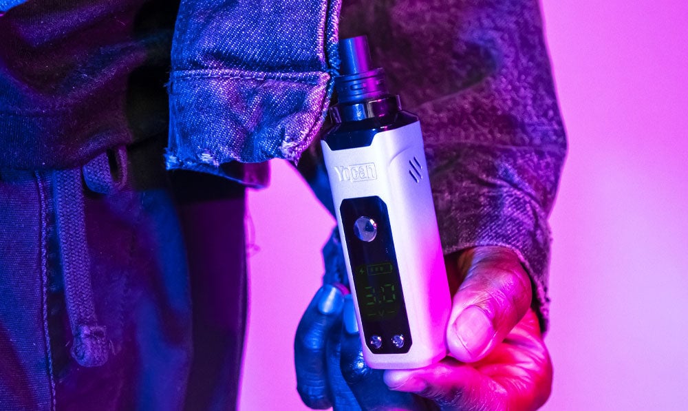 Man holding Wulf Nestor in front of blue and purple lighting
