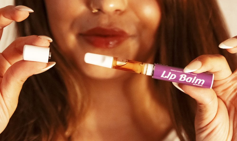 Woman holding Smyle Chapstick apart