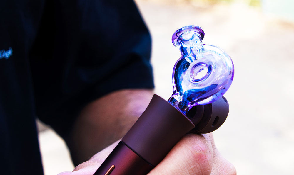 Closeup of man holding Wulf Mods Ring Puffco Pivot Top attached to Pivot