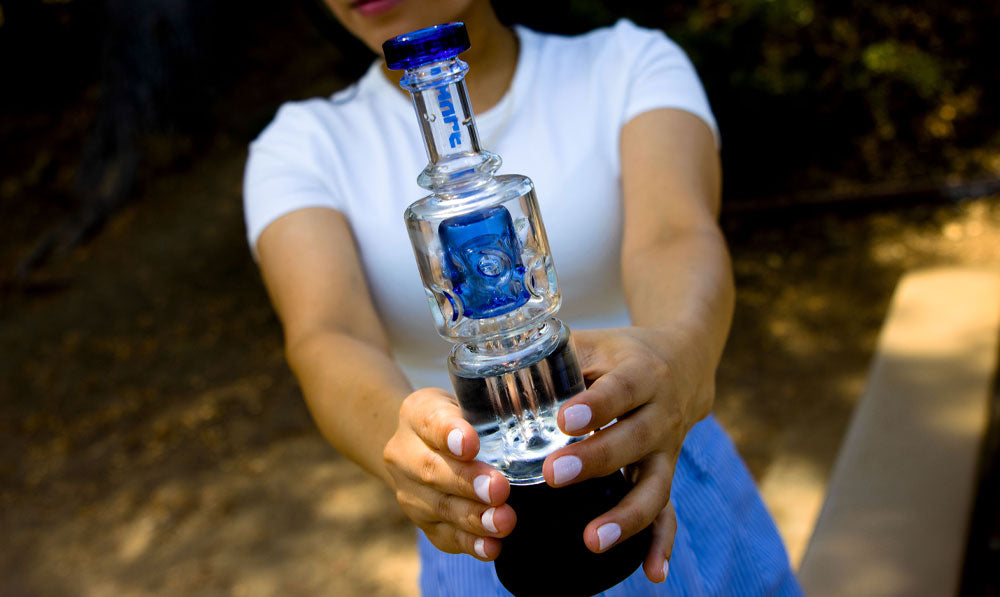 woman holding Wulf Fuse Puffco Peak Top at park