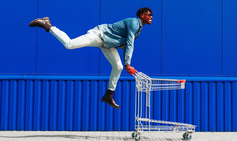 Happy Black Friday Shopper Jumping With Cart