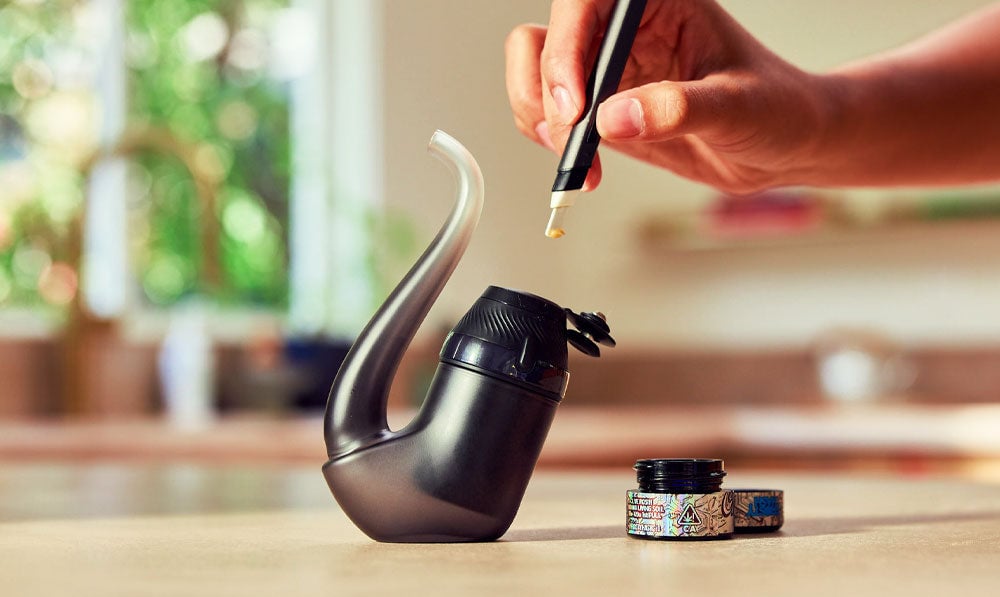 Person using Puffco New Proxy on kitchen counter