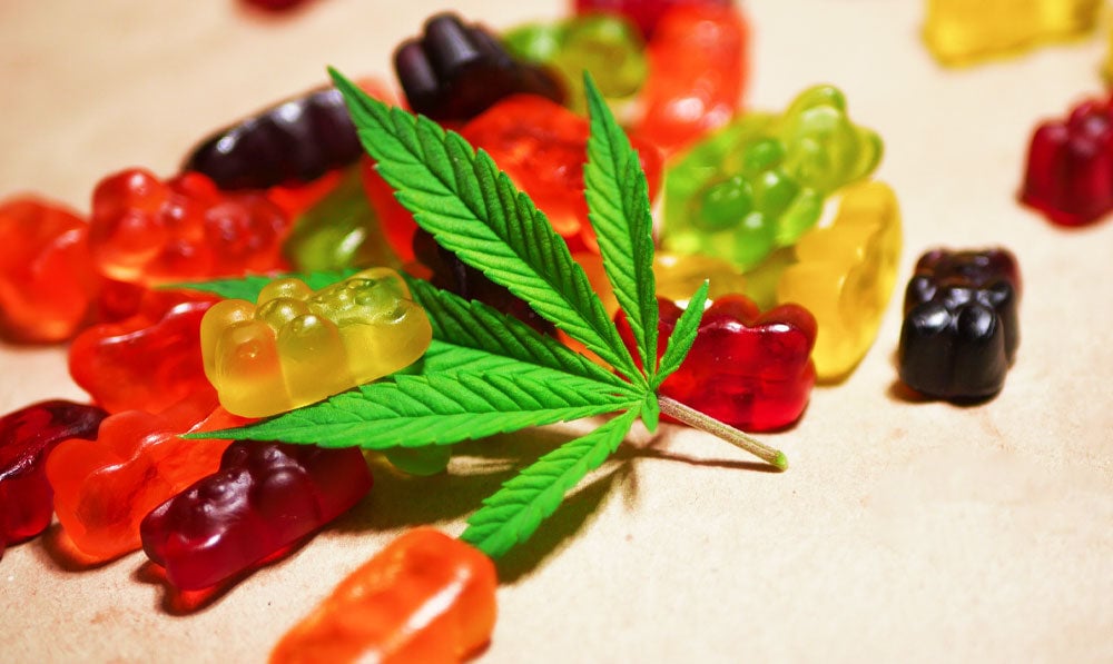 Thc Leaf Lying In Pile Of Gummies
