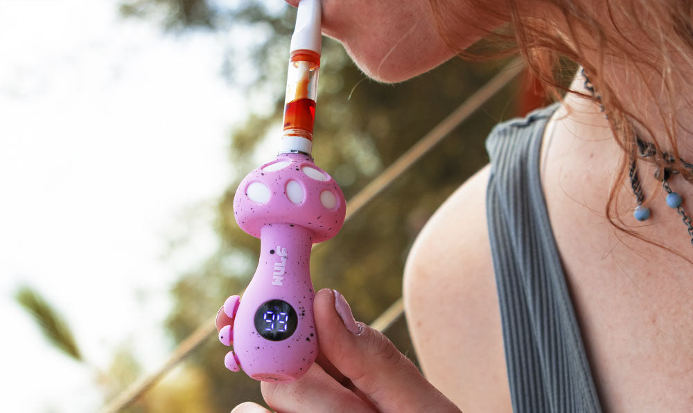 Woman holding pink Wulf Mods Tryp on a nature trail