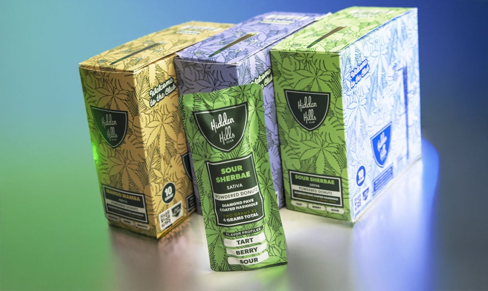 Hidden Hills Powdered Donutz Pre rolls on display with green and purple studio lighting