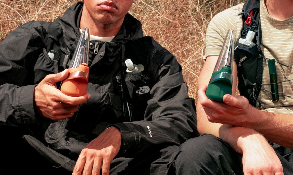 Two male hikers holding Puffco Peak Canyon and Pine on a trail