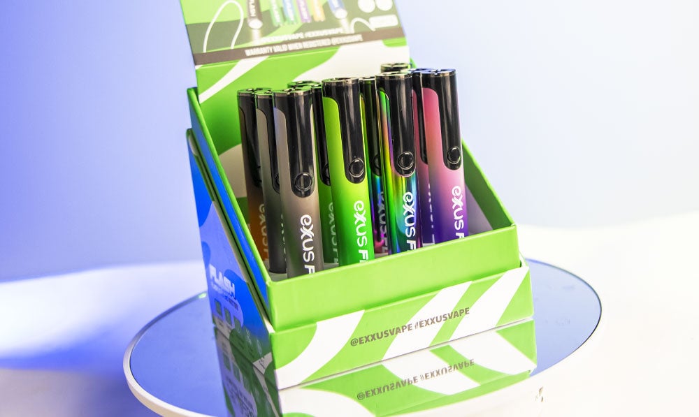 Exxus Flash Battery 12pk on reflective circular surface