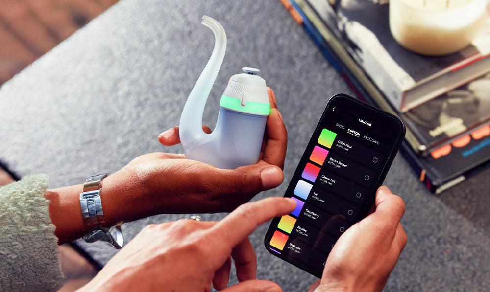 Two people configuring Puffco New Proxy via Bluetooth