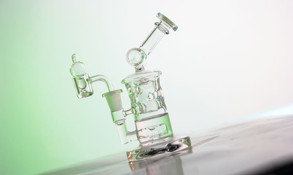 Wulf Mods Tyde Dab Rig on marble surface with soft green background lighting