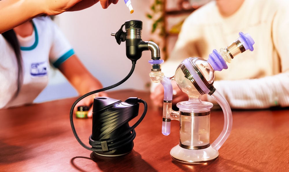 Two People Using Puffco Link With Waterpipe