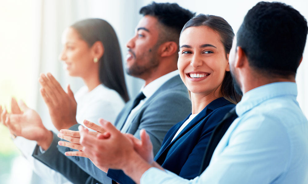 Smiling audience applauding at a trade show