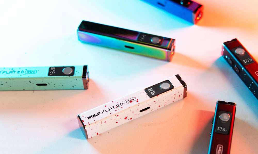 Wulf Mods Flat Mini 2.0 units scattered on white surface with colorful lighting