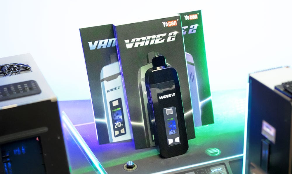 Yocan Vane 2 on futuristic display platform with wires running and neon lighting