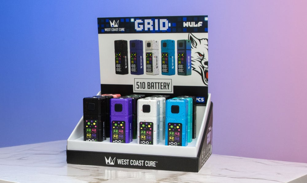 West Coast Cure Grid 12pk standing on white marble table with colorful background